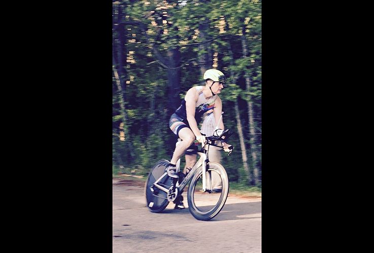 Dr. Pate riding bike in woods