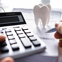 a person calculating the cost of veneers