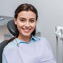 Young woman smiling after receiving dental implants