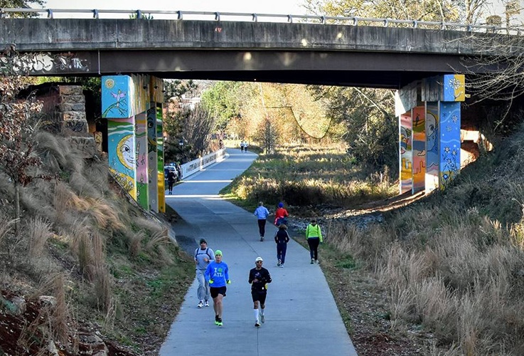 Dr. Pate running under a bridge