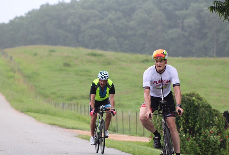 Dr. Pate riding bike near field