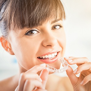 Woman placing ClearCorrect aligner