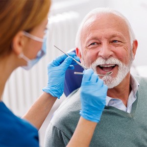 Mature man smiling during dental checkup 