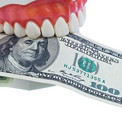 Dental mold biting $100 bill