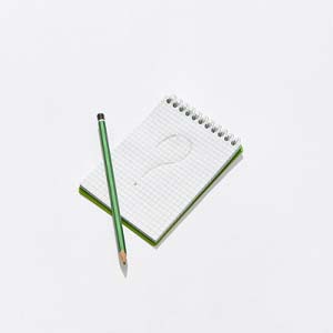 Question mark on notepad and green pencil