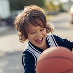 Little boy playing basketball