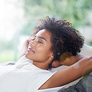 Relaxing woman with hands behind head