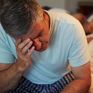 Frustrated man with head in hands