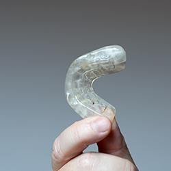 Hand holding an occlusal splint