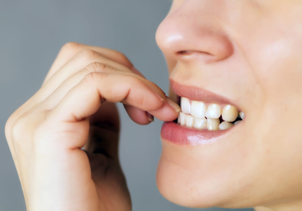 Woman biting her nails 