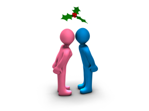 boy and girl kissing under the mistletoe