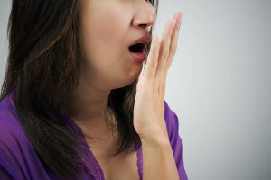 Woman with a knocked-out tooth with her hand over her mouth