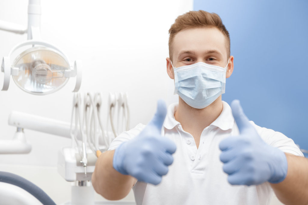 A hygienist practices social distancing in dentist offices. 